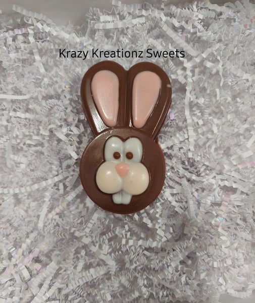 Chocolate bunny decoration on a textured white surface with 'Krazy Kreationz Sweets' branding.